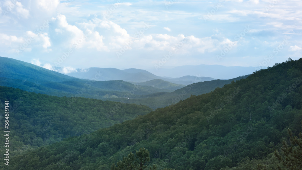 The ridge tops of the Blue Ridge mountains appear to go forever beyond the horizon.