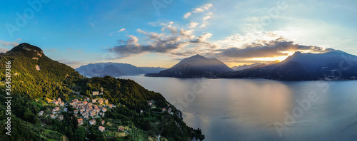 beautiful aerial panorama of village by lake como italy during sunset light with lake and mountains in background photo