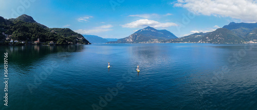 two stand up paddle boarders at lake como at sunrise/ stand up paddling/ surf italy