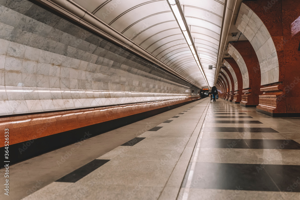Long platform of underground, station interior. Abstract perspective view, lonely people