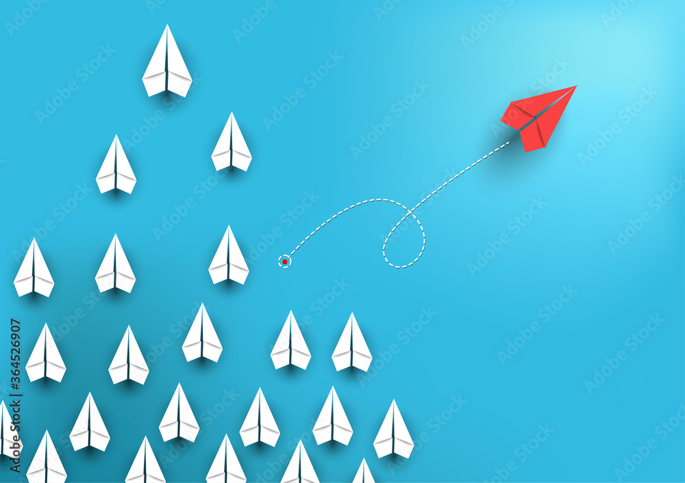 Group of paper airplanes flying.Paper plant in one direction and one red paper plant pointing in different way.