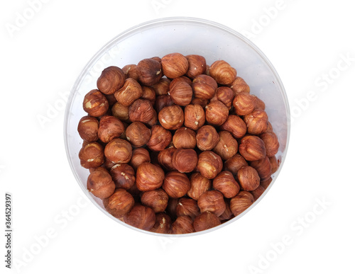 fried hazelnuts in a bucket on a white background