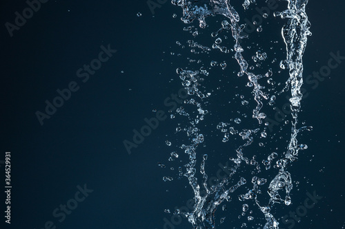 Clear, beautiful splash with drops on the water surface