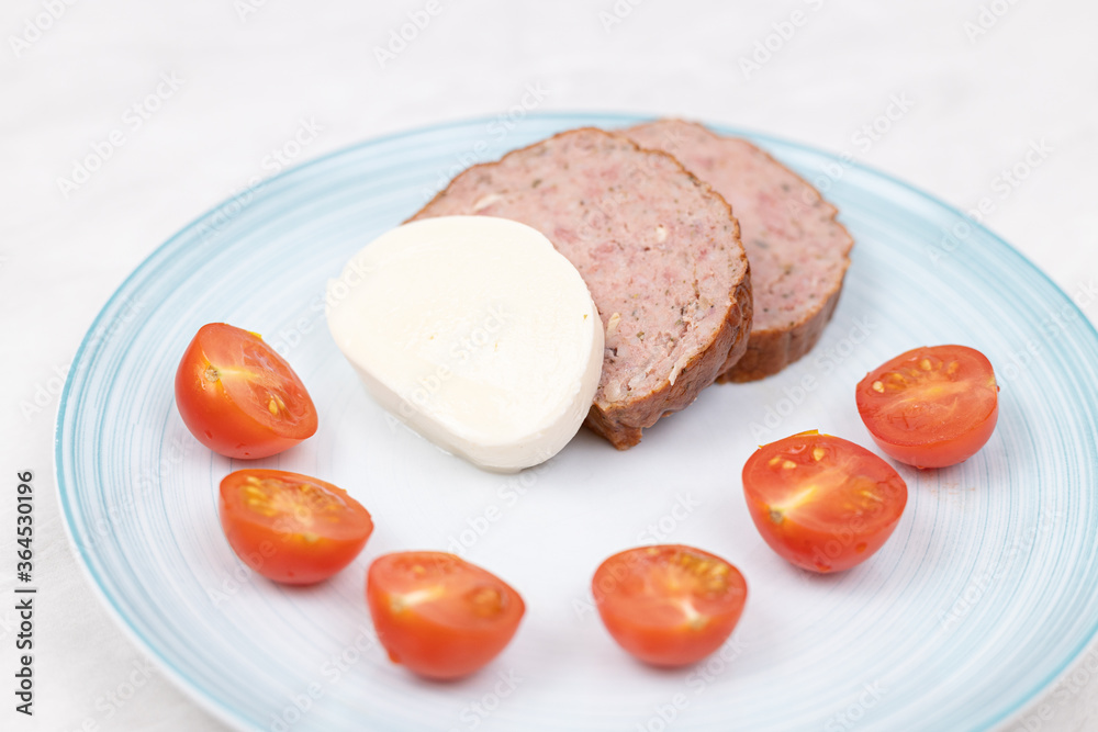 Sliced Meatloaf served with cheese and cherry tomatoes Sliced Meatloaf served with cheese and cherry tomatoes