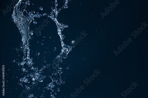 Abstract splash of water on black background. Texture of water. Elements of design. Waterfall. Shower. Watering. The stream of water . Quench thirst.
