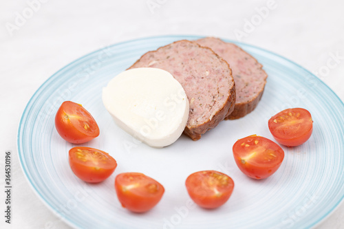 Sliced Meatloaf served with cheese and cherry tomatoes