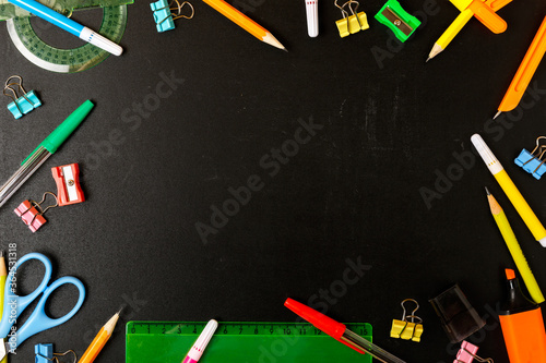 Frame of school stationery on a black school board. Concept back to school. School shop concept. Copy space, flat lay, top view, background.