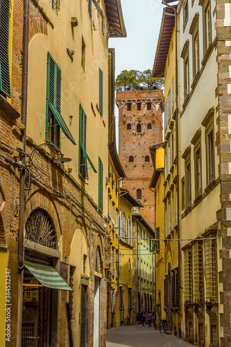 A view along the streets towards the Guinigi Tower in Lucca, Italy in summer