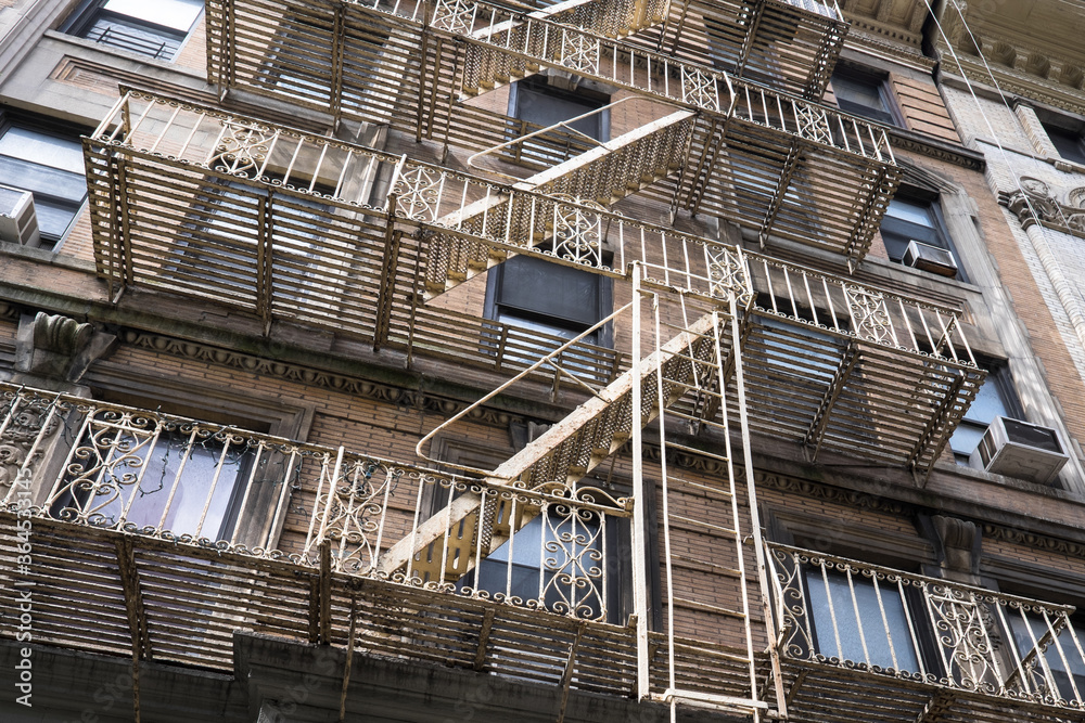 Typical industrial building in New York with fire escape ladders in New York, USA
