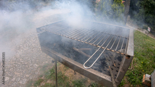 Preparation of barbecue with charcoal at the Picnic Park of Alvaraes in Viana do Castelo, Portugal. Background of smoldering charcoal. BBQ with embers. photo