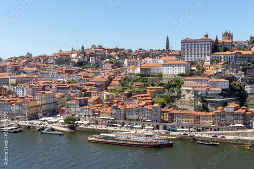 Fototapeta Naklejka Na Ścianę i Meble -  Colorful houses of Porto Ribeira, traditional facades, old multi-colored houses with red roof tiles on the embankment in the city of Porto, Portugal. Unesco World Heritage site.