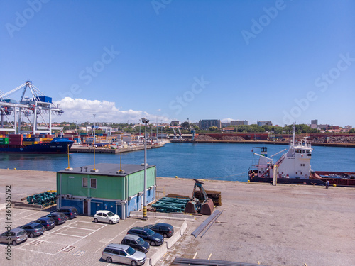 Matosinhos / Portugal - July 2, 2020: Aerial view of the TCL - Terminal de Contentores de Leixões, S.A., (Leixões Container Terminal). Loading container to ship by industrial line gantry crane. photo