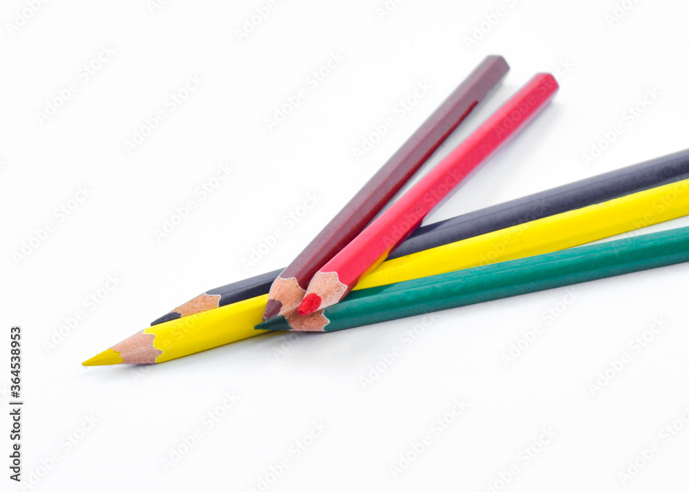 Five different color wood pencil crayon placed two on top of three crayons Five different color wood pencil crayon placed two on top of three crayons