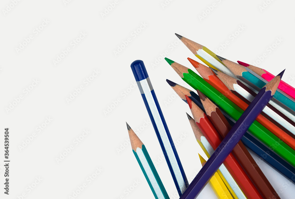 Many different colored wood pencil crayons placed on a white background
