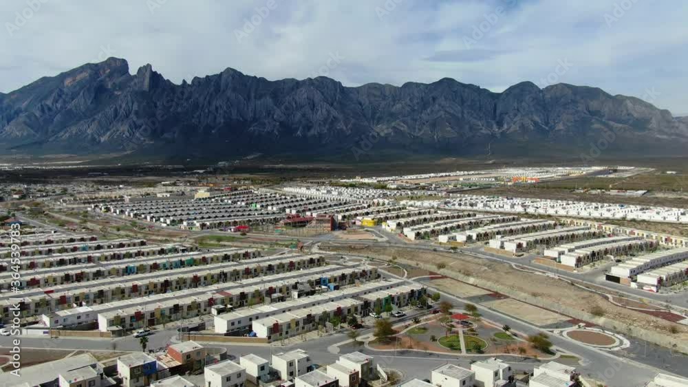 New neighborhoods of Monterrey in Mexico built on field surrounded by high mountains New neighborhoods of Monterrey in Mexico built on field surrounded by high mountains