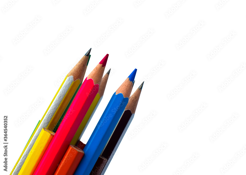 Pile of different colored wood pencil crayon placed on a white background Pile of different colored wood pencil crayon placed on a white background