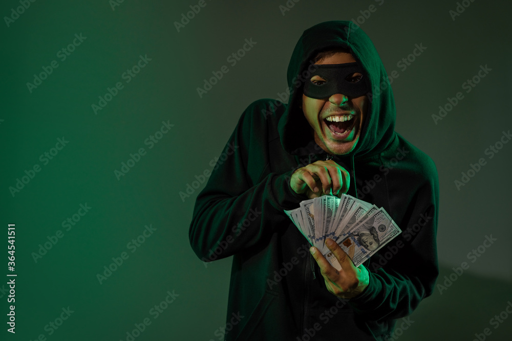 Photo & Art Print Portrait of the gloating male thief with dollar