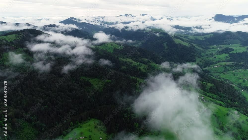 Flying through the clouds above mountain tops. High peaks with Forest, wonderful natural Landscape Flying through the clouds above mountain tops. High peaks with Forest, wonderful natural Landscape