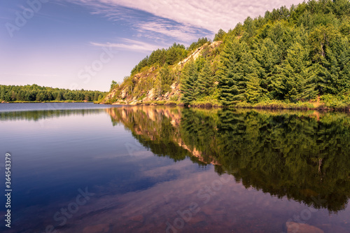 View of a lake in Sudbury with the forest reflected on the water
