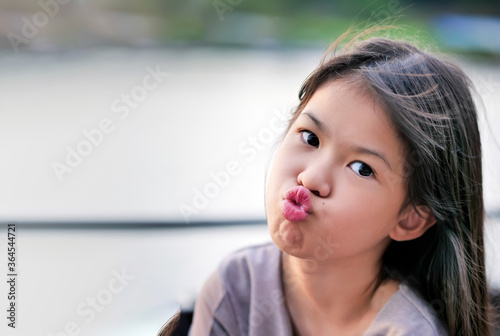 Portrait of cute lovely girl in casual outfit with sending blowing kiss