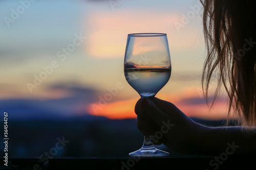 Glass of  wine on sunset background.