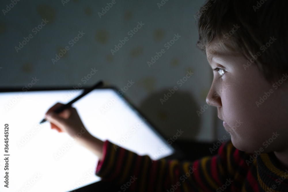 Child do homework on a graphic tablet at home. Child do homework on a graphic tablet at home.