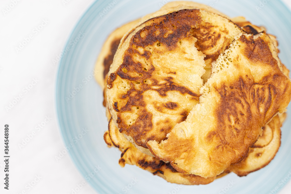 Top view of stacked pancakes served on the plate Top view of stacked pancakes served on the plate