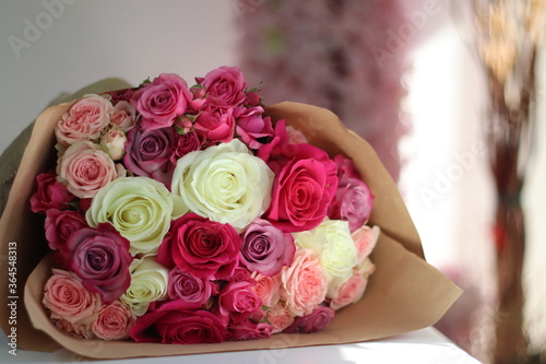 a beautiful bouquet with pink and white blooming roses for a bride during her wedding