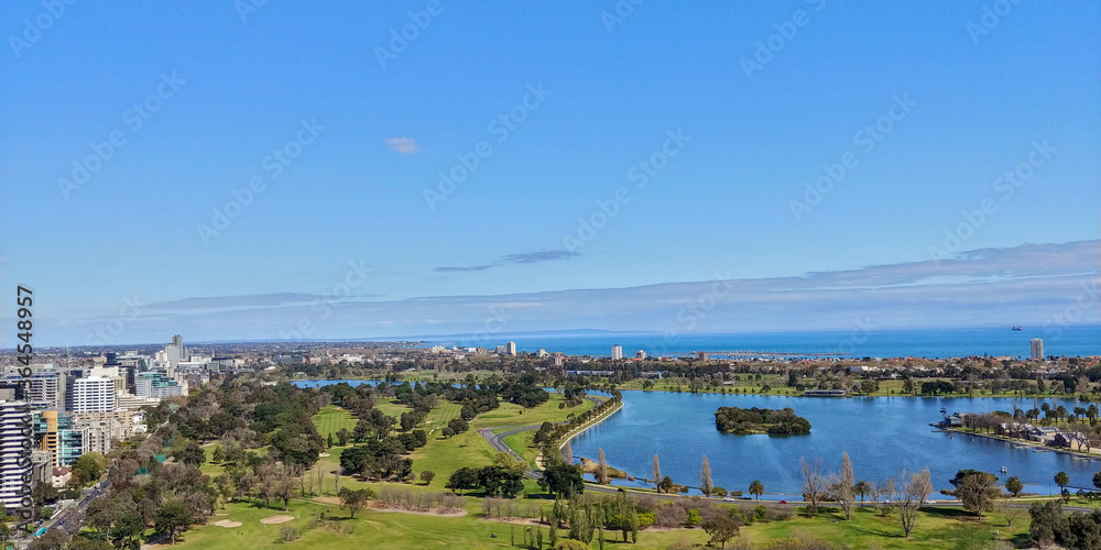 Aerial view of a beautiful sunny day at the Albert Park and Lake, with the golf course and Melbourne Skyline