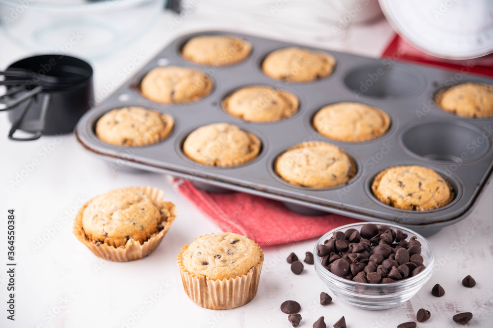 chocolate chip muffin on white wooden board chocolate chip muffin on white wooden board