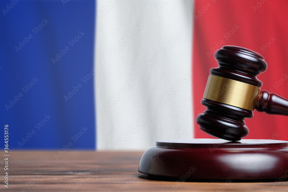 Justice and court concept in French Republic France. Judge hammer on a flag background