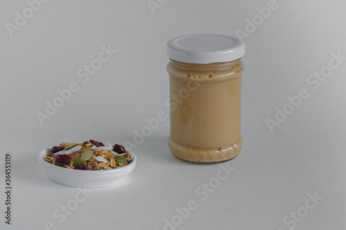 Granola and peanut butter on a white background