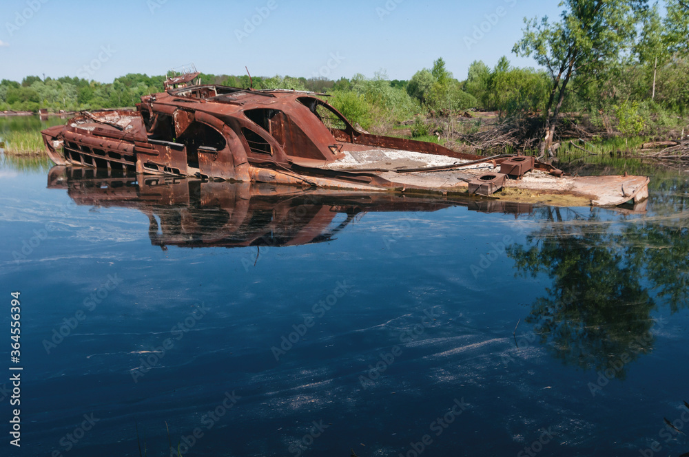 Abandoned sunken Barges Boats On River Pripyat in Chernobyl exclusion Zone. Chernobyl Nuclear Power Plant Zone of Alienation in Ukraine Abandoned sunken Barges Boats On River Pripyat in Chernobyl exclusion Zone. Chernobyl Nuclear Power Plant Zone of Alienation in Ukraine