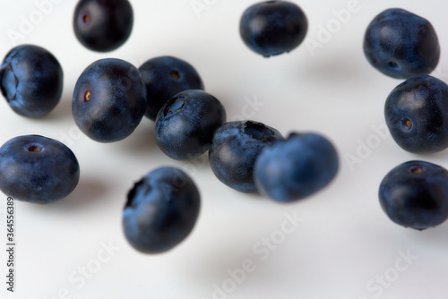 falling blueberries on a white background
