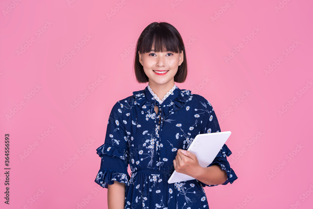 Asian attractive cute short hair woman happy smiling using smart tablet device technology confident independent mother businesswoman planning research wearing dress pink isolated background portrait Asian attractive cute short hair woman happy smiling using smart tablet device technology confident independent mother businesswoman planning research wearing dress pink isolated background portrait