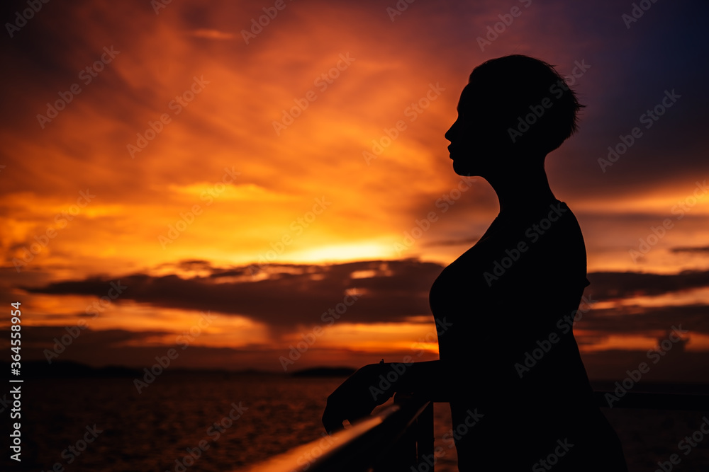 Silhouette of a girl on a sunset background.
