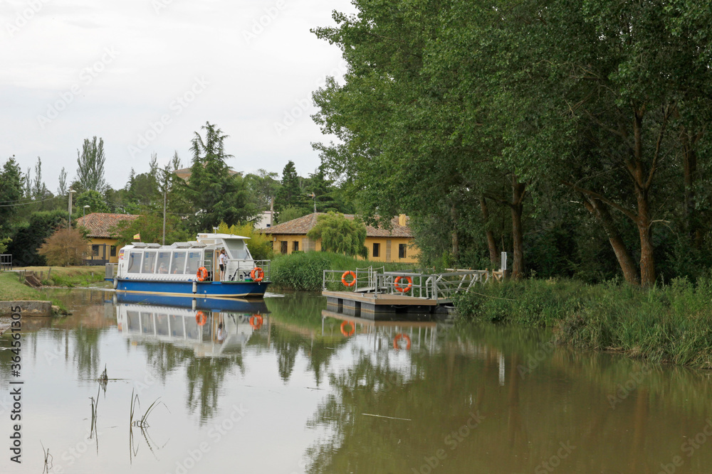 Recreational electric boat used in the Canal of Castilla near the town of Fromista, province of Palencia, north Spain Recreational electric boat used in the Canal of Castilla near the town of Fromista, province of Palencia, north Spain