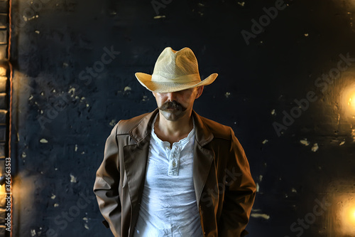 stylized vintage portrait of a man wild west, mustachioed dangerous criminal, mustache on his face © kichigin19