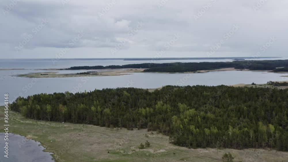 Flying over beautiful forested island on a cloudy day Flying over beautiful forested island on a cloudy day