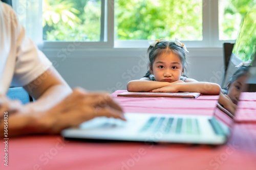 Daughter wait for her dad working.