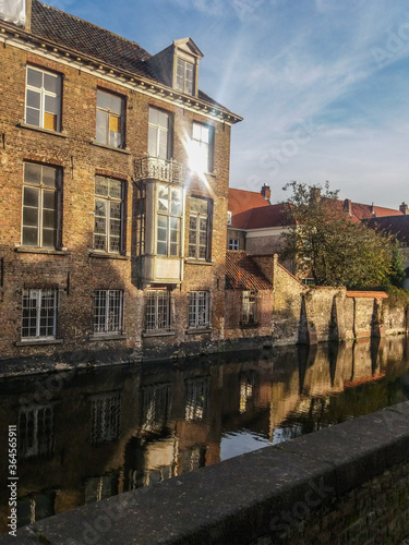 Canal and old buildings in the medieval city of Bruges in northern Belgium. This city is known as Venice of the North by its canals in the center of the city.