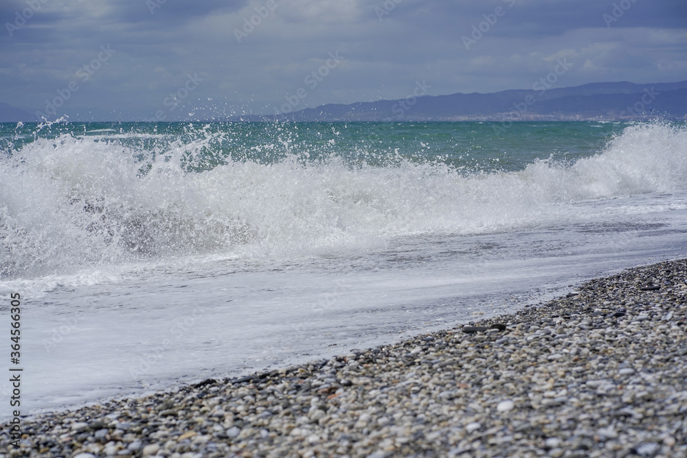 Pebble close up from a spanish shore with waves Pebble close up from a spanish shore with waves