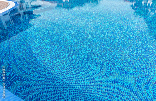 Elements of a swimming pool. Beautiful swimming pool with blue tiles closeup. © Denis Rozhnovsky