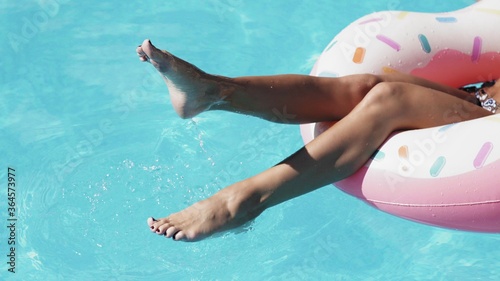 Beautiful Female legs splashing in pool.