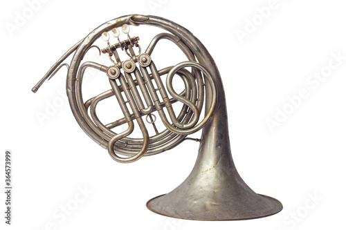 Old vintage silver French horn on a on white background