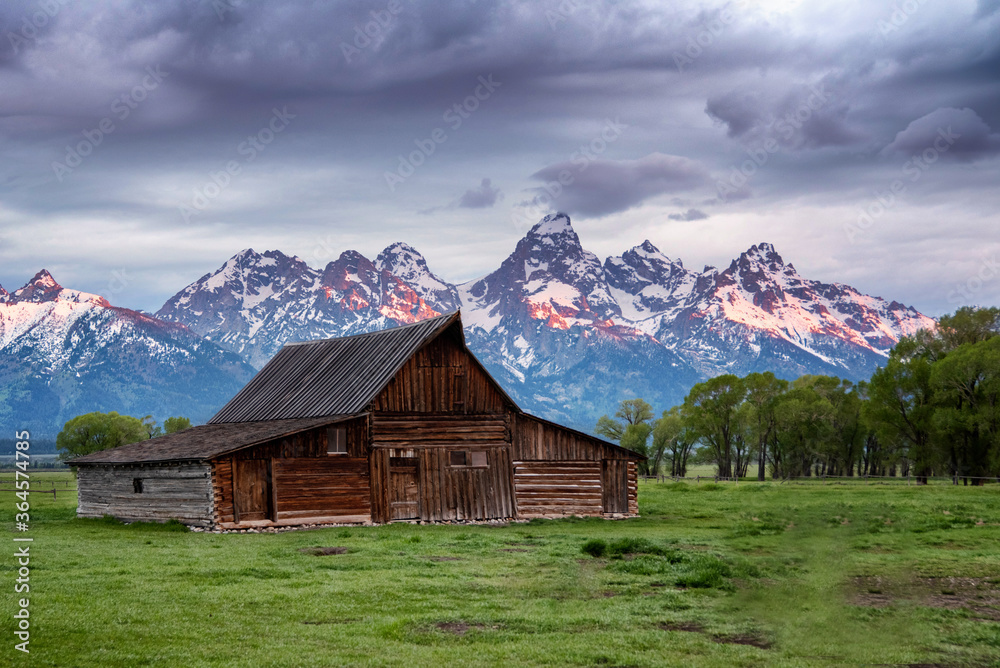 Mormon Row in Jackson Hole, Wyoming on a partially cloudy day Mormon Row in Jackson Hole, Wyoming on a partially cloudy day