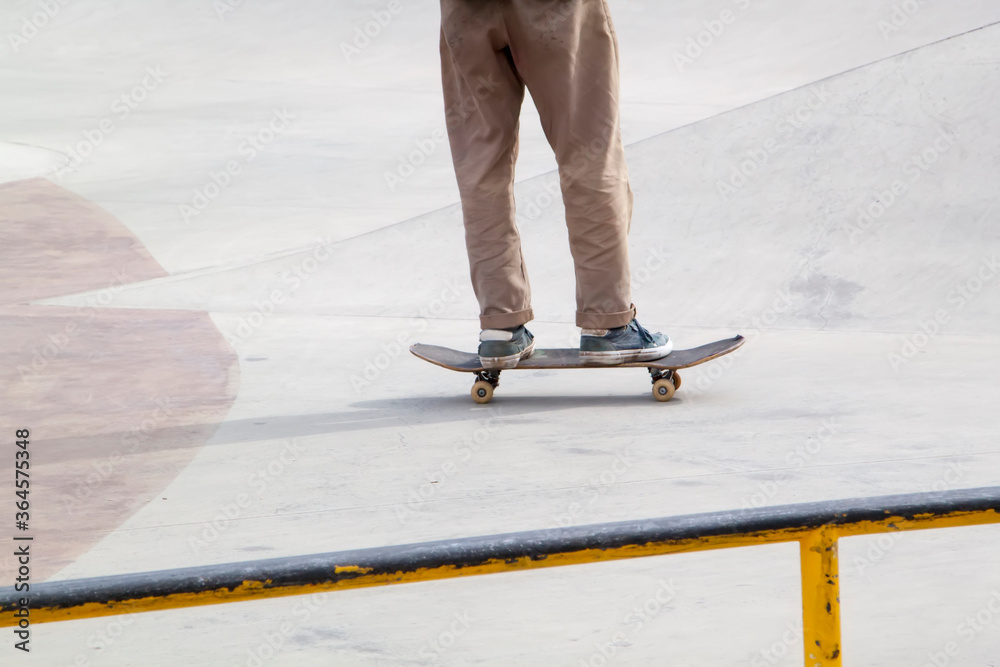 Young man practising on skateboard in skate park Young man practising on skateboard in skate park
