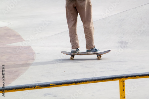 Young man practising on skateboard in skate park