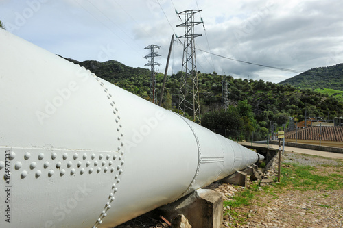 Sustainable production of renewable power electricity. Large water pipe for the gravity feed of Las Buitreras Hydroelectric Power Plant in El Colmenar in the province of Malaga, Spain.  photo