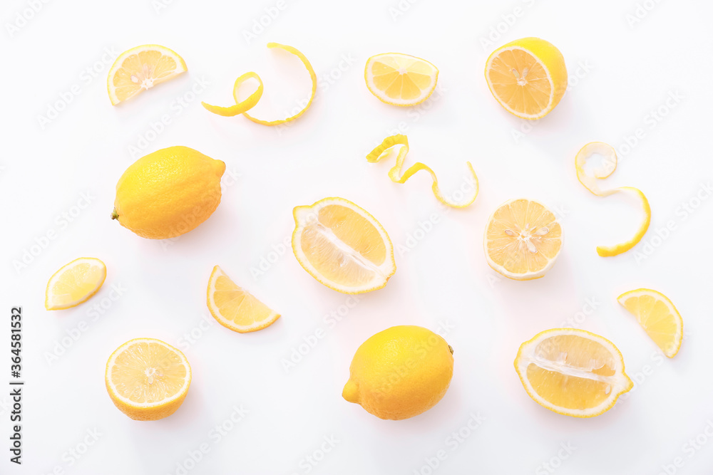Fresh whole and cutted lemons on white background. Fresh citrus fruit background. Top view
